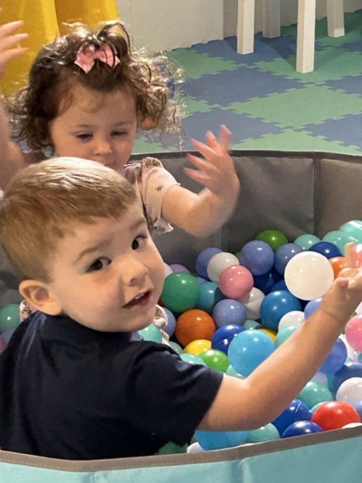 Children playing together in a ball pit