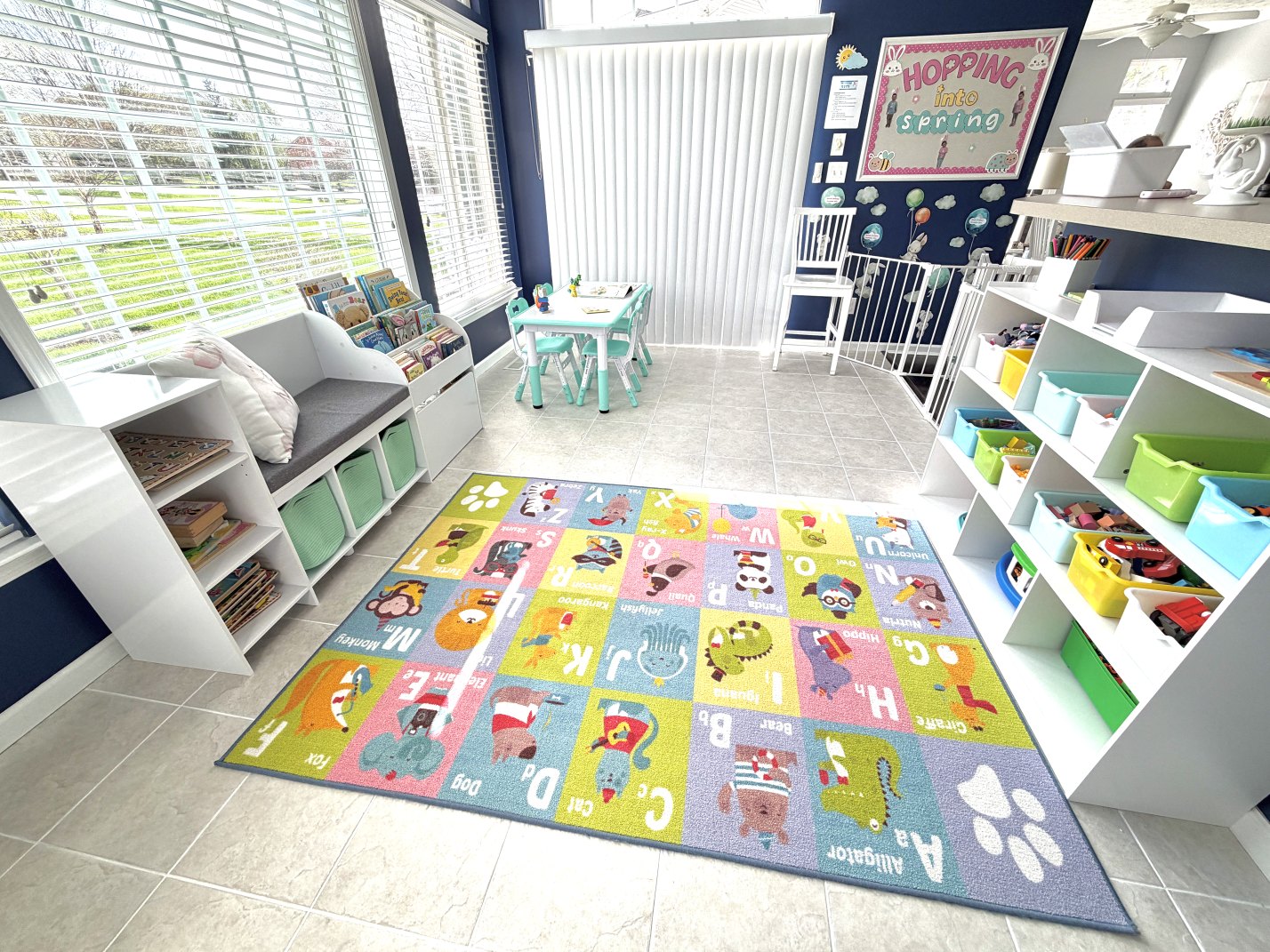 Bright classroom space at Cottontail Childcare in Springboro with books, toys, and an alphabet rug